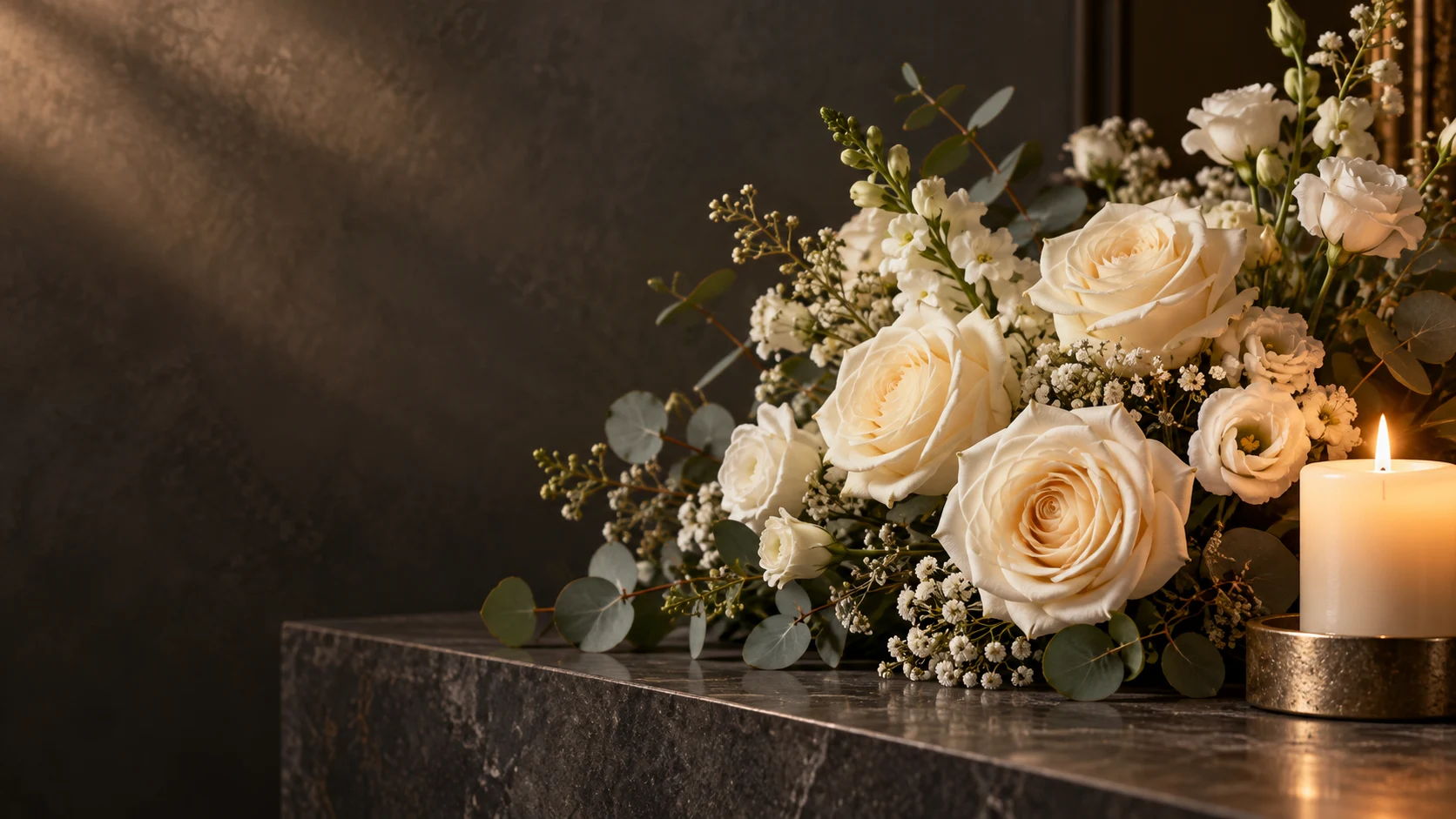 Ivory roses beside warm candlelight